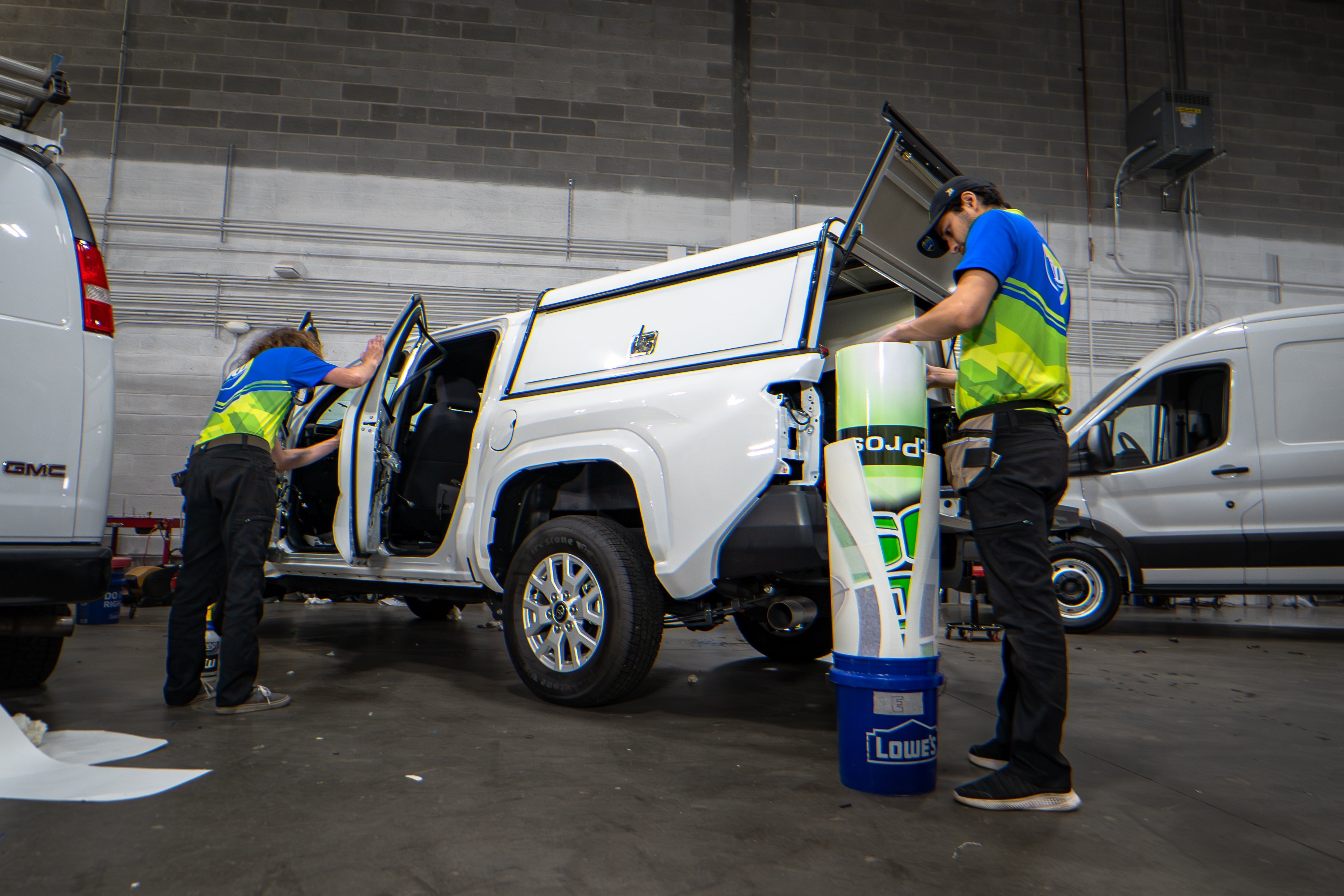TradeWraps installer applying commercial vehicle wrap in Manassas Virginia