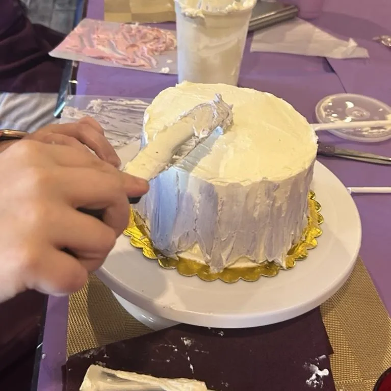Guests decorating cakes during a Cake n Sip class