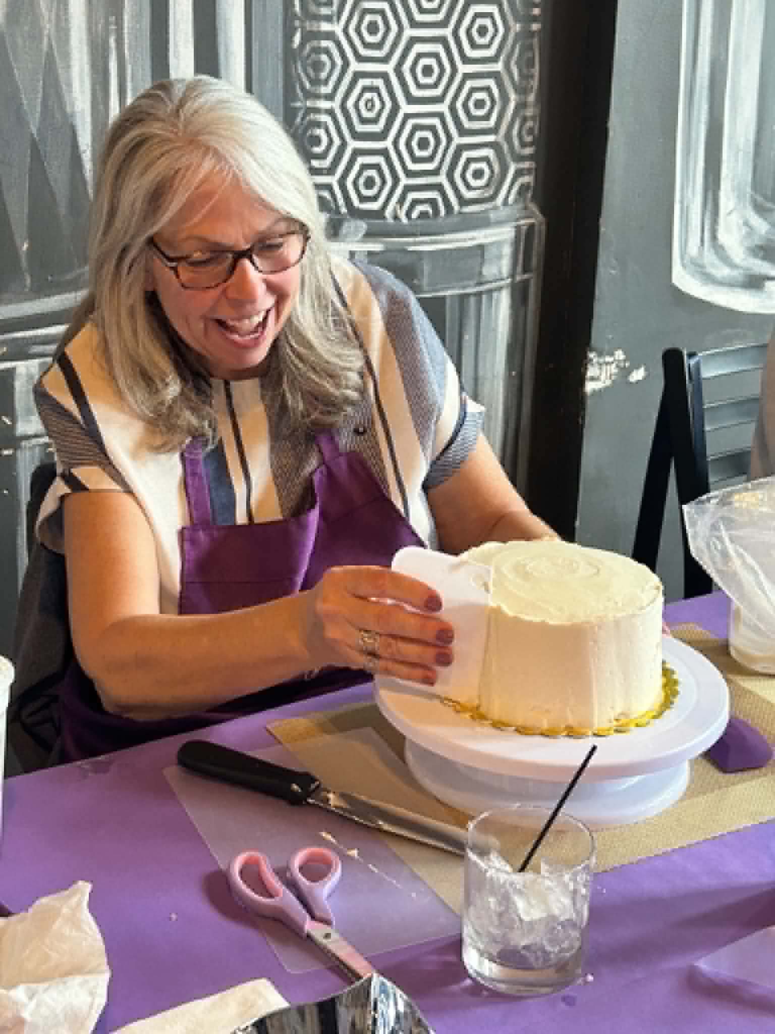 Guests decorating cakes during a Cake n Sip class