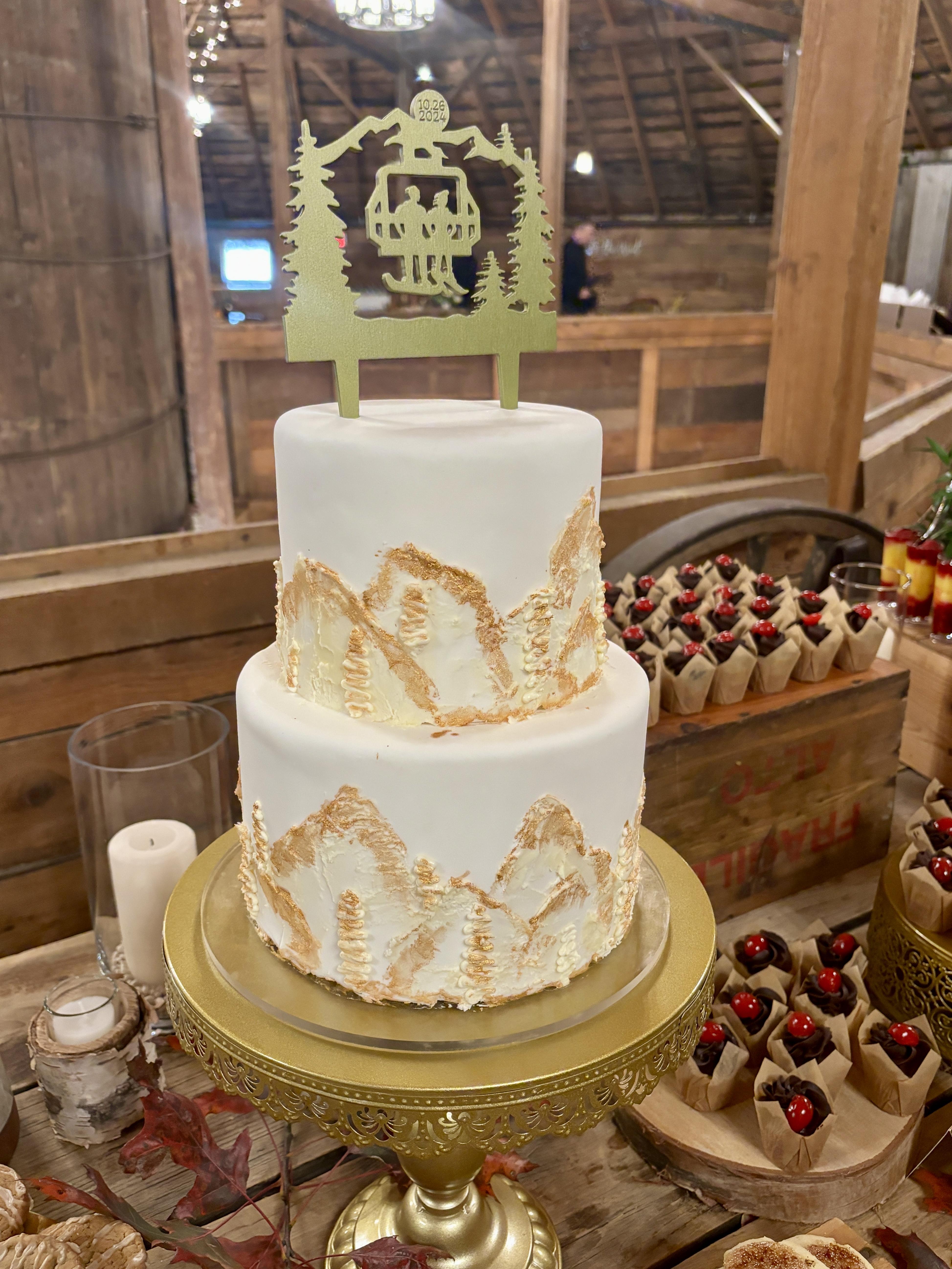 Elegant tiered artisan wedding cake in blush and ivory tones