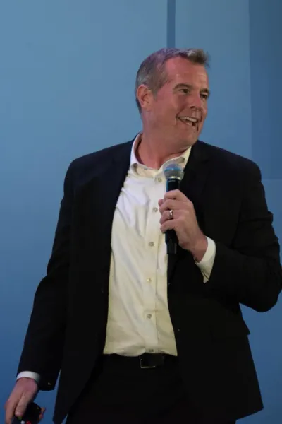 Dr. Danny Brassell delivering a keynote on communication, clarity, and audience understanding