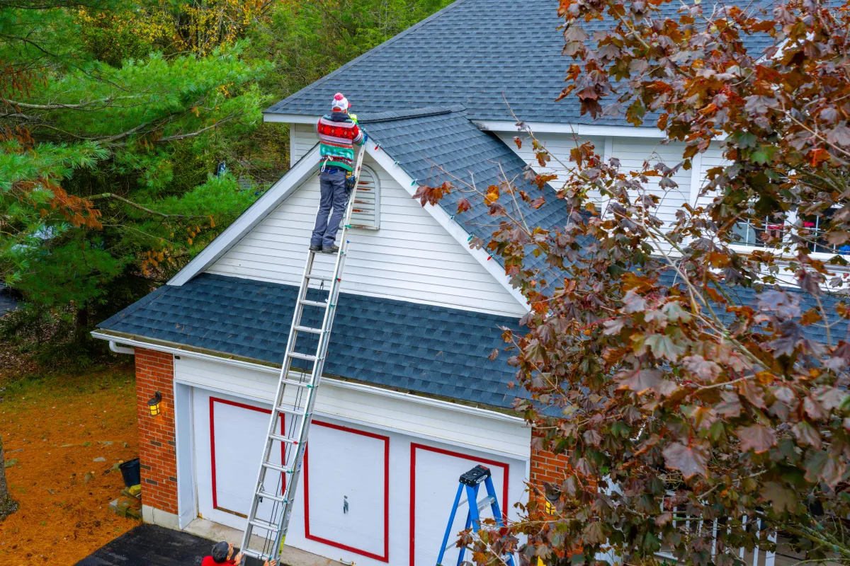 Holiday lights being installed on a home
