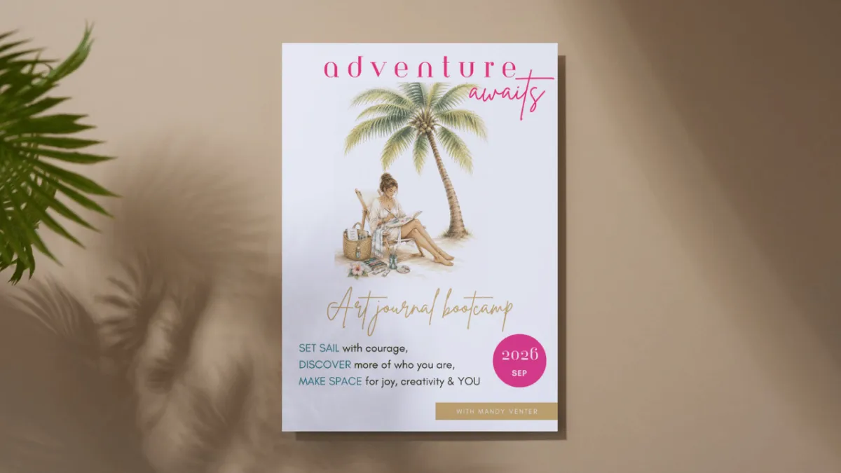 Flatlay photograph showing a printed workbook titled 'RENEW Art journal with purpose' resting on sand, next to a folded blue and white striped towel and round pink sunglasses.