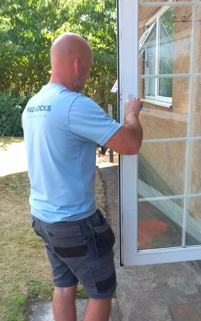 Lee Armitage of Pad-Locks Locksmiths repairing a uPVC patio door lock mechanism in Chorley.