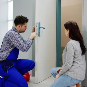 Locksmith technician installing a smart lock on a residential property