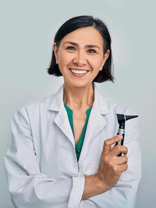 female audiologist holding an otoscope