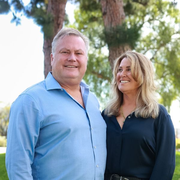owners standing outside and smiling