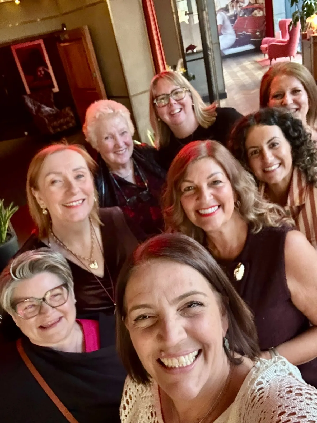 An image of Sandra at an event with some existing Amplify members