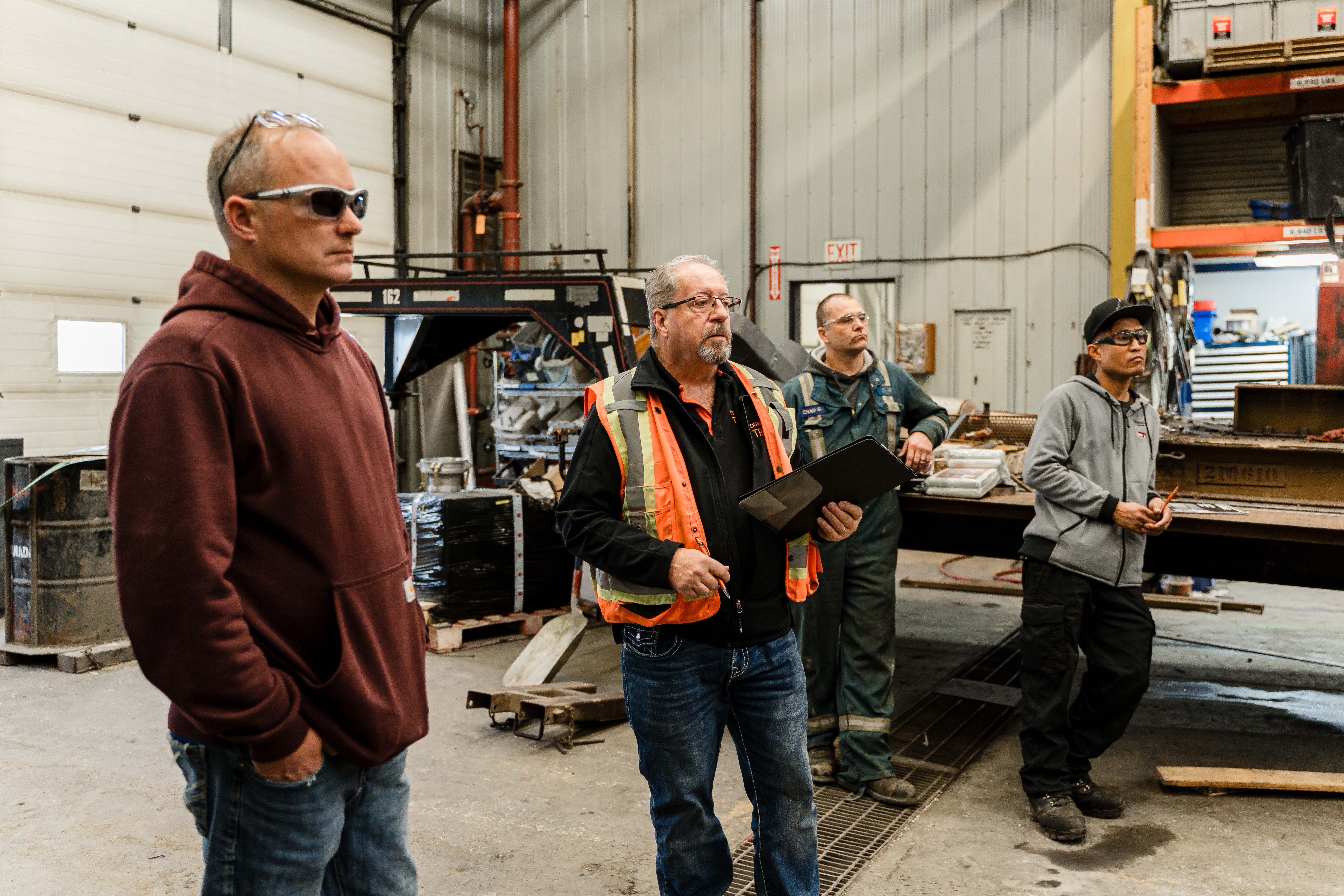 Isolated industrial forklift in studio lighting, full machine visible and centered, high-detail photographic study with neutral clipping (no background), crisp steel textures highlighting safety decals and operator compartment.