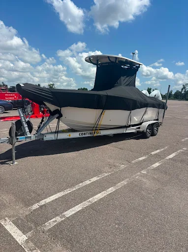All Florida Yacht Sales — consignment boat wrapped and ready for transport on trailer at AFYS Ruskin Florida lot