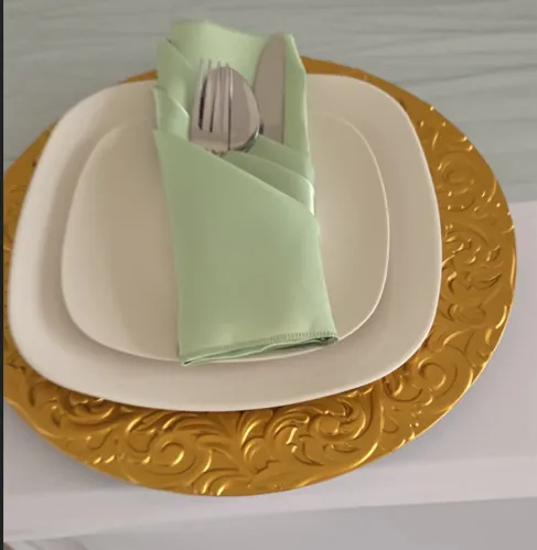 A formal place setting with a floral plate and napkin.