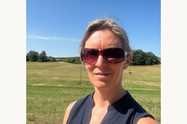 Johanna Urquhart, leadership coach and founder of Resta Forte, walking through vineyards near her home in Piemonte