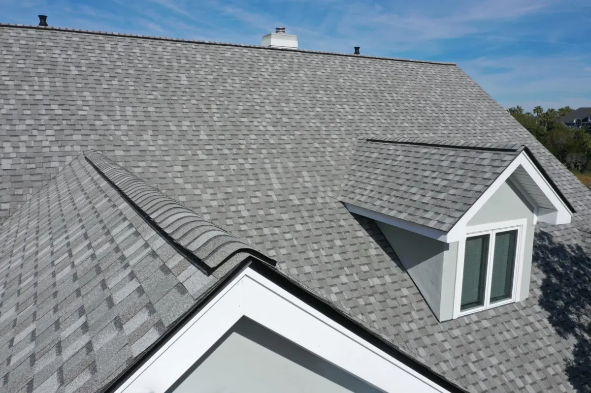 a newly installed shingle roofing of a house