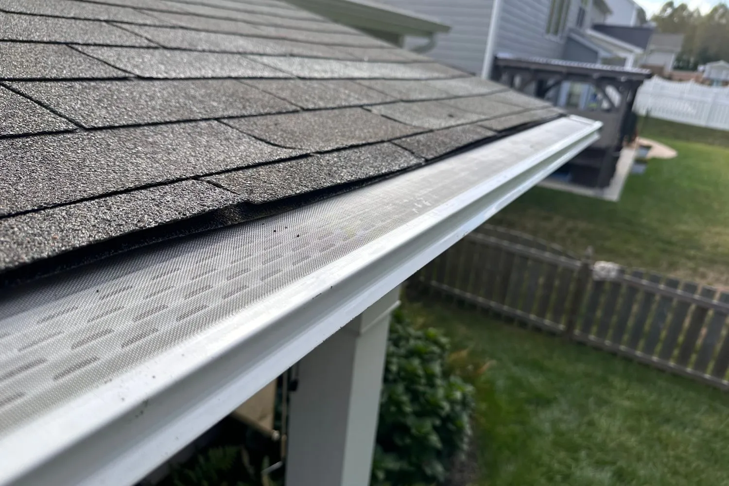 a newly installed gutter with metal guard