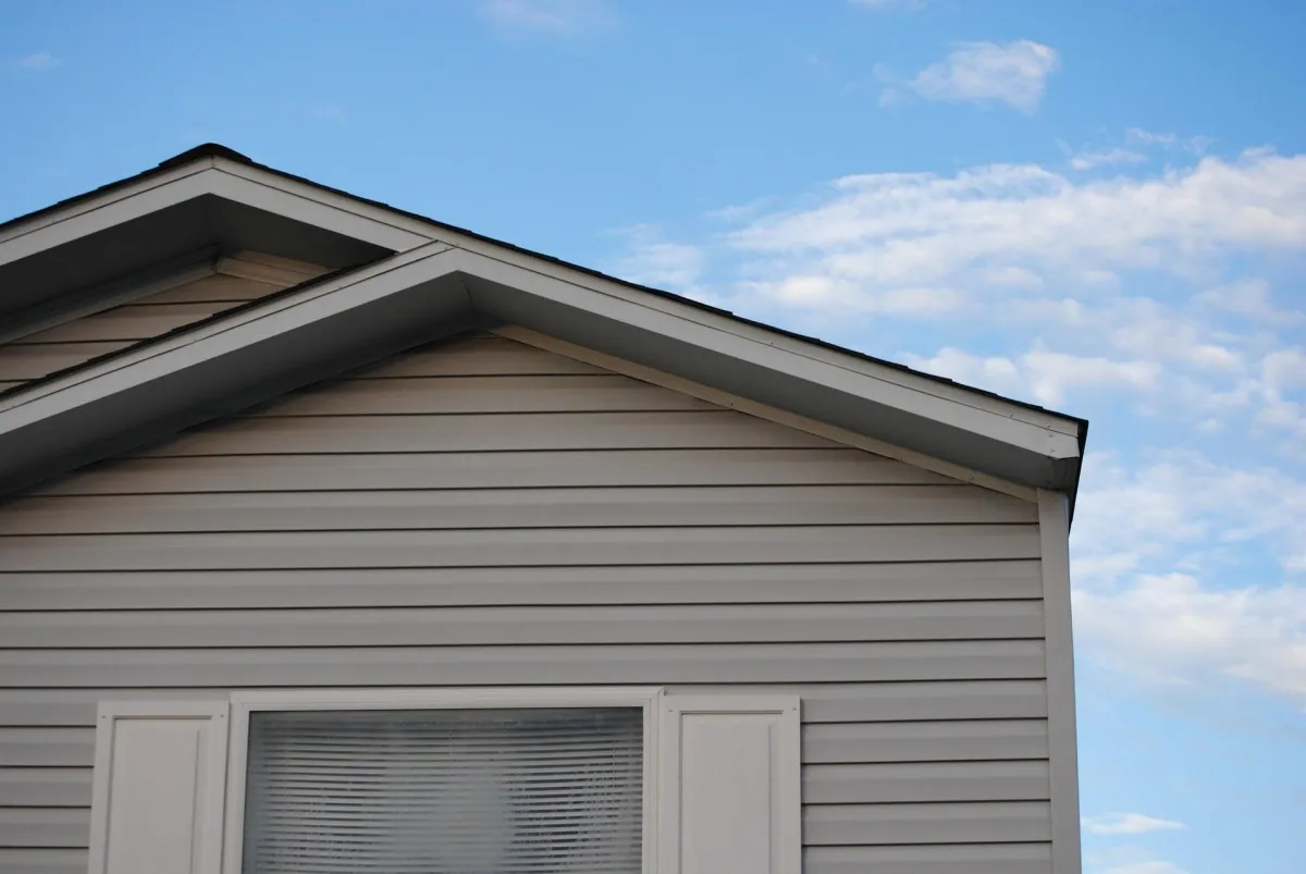 a vinyl siding if a house with white windows