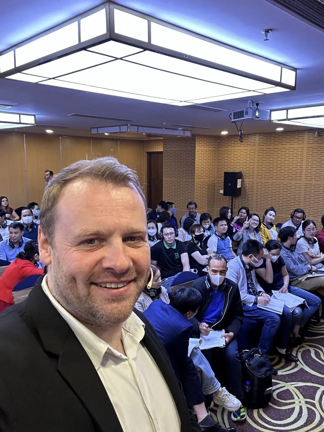 Alasdair Cunningham with a full room of attendees at a business event in Vietnam