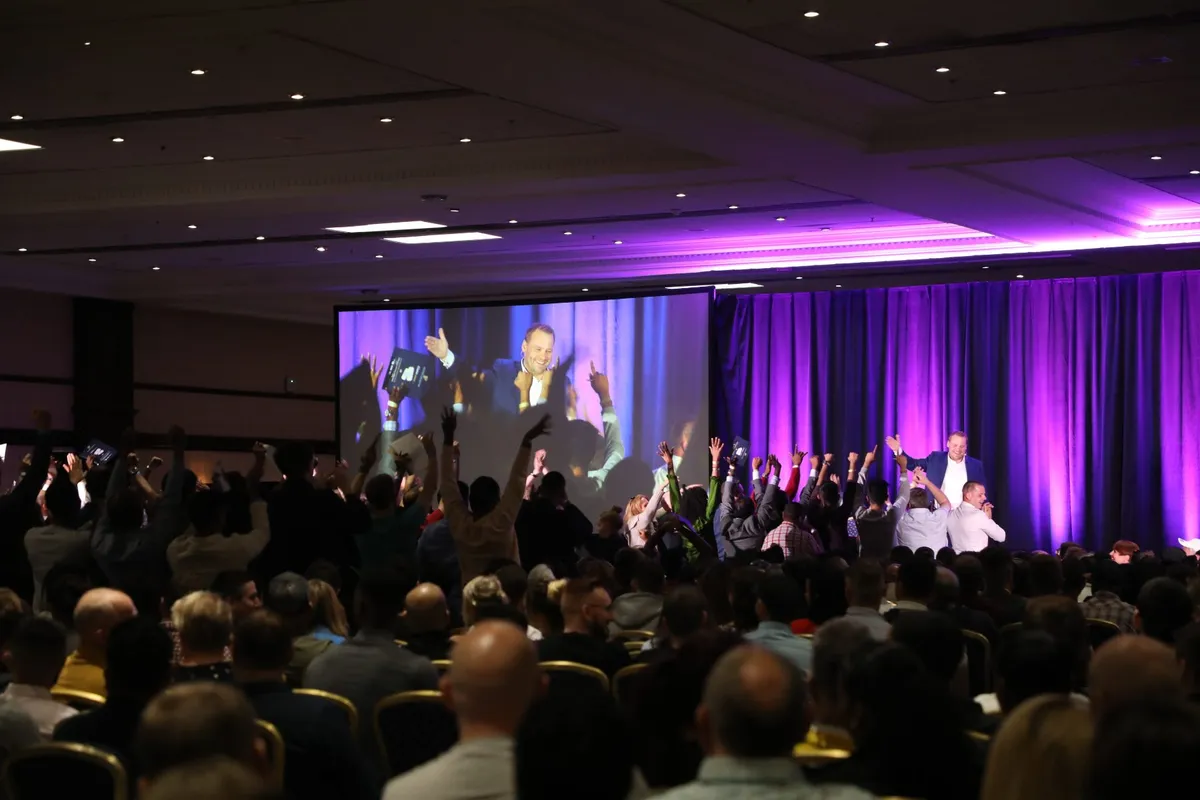 Packed conference hall at a UK business event where Alasdair Cunningham spoke