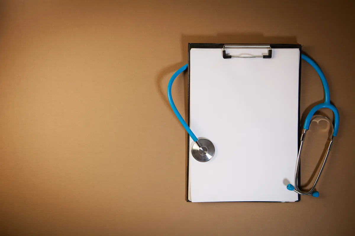 Clipboard and stethoscope representing the life insurance underwriting process