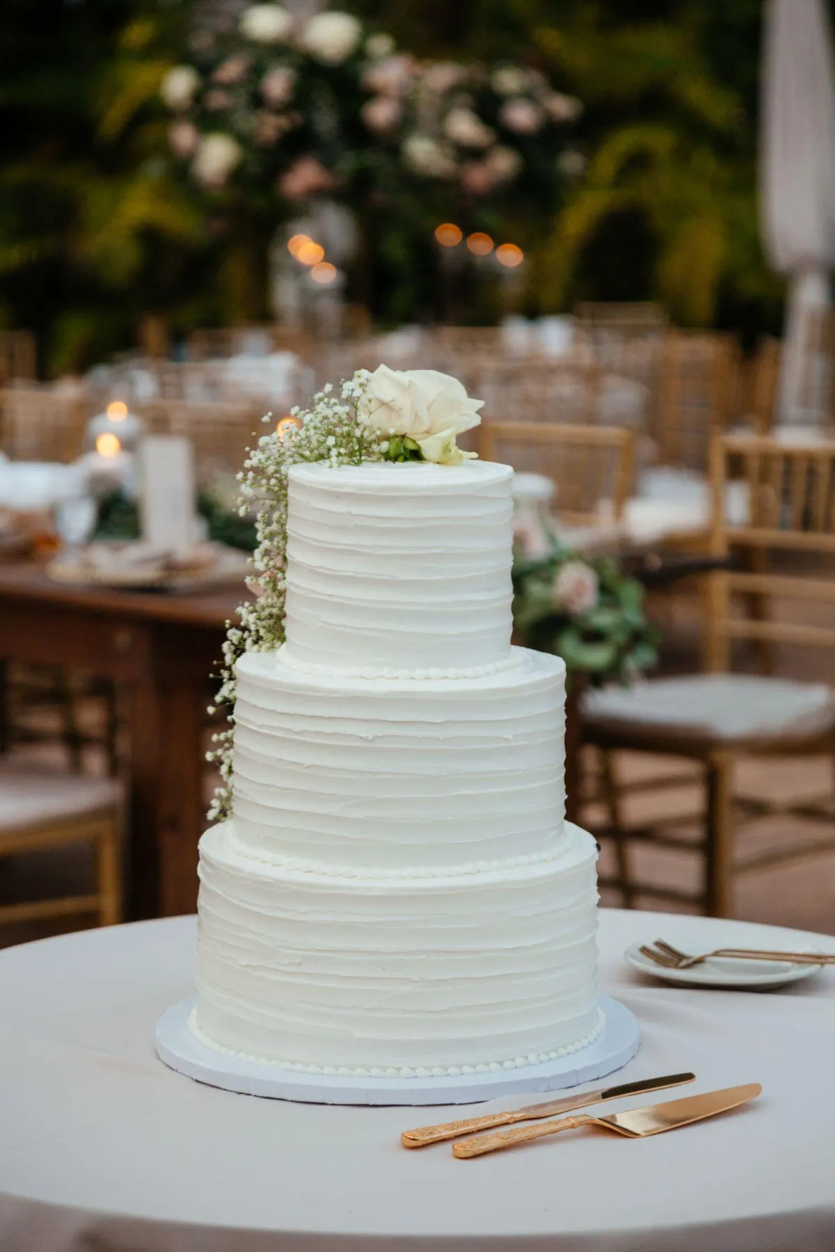 Naked wedding cake adorned with flowers for a touch of charm