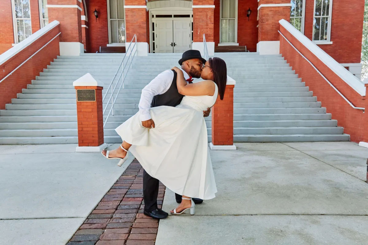 Groom and Bride romantically embracing eachother at Osceola County Courthouse in Kissimmee, FL