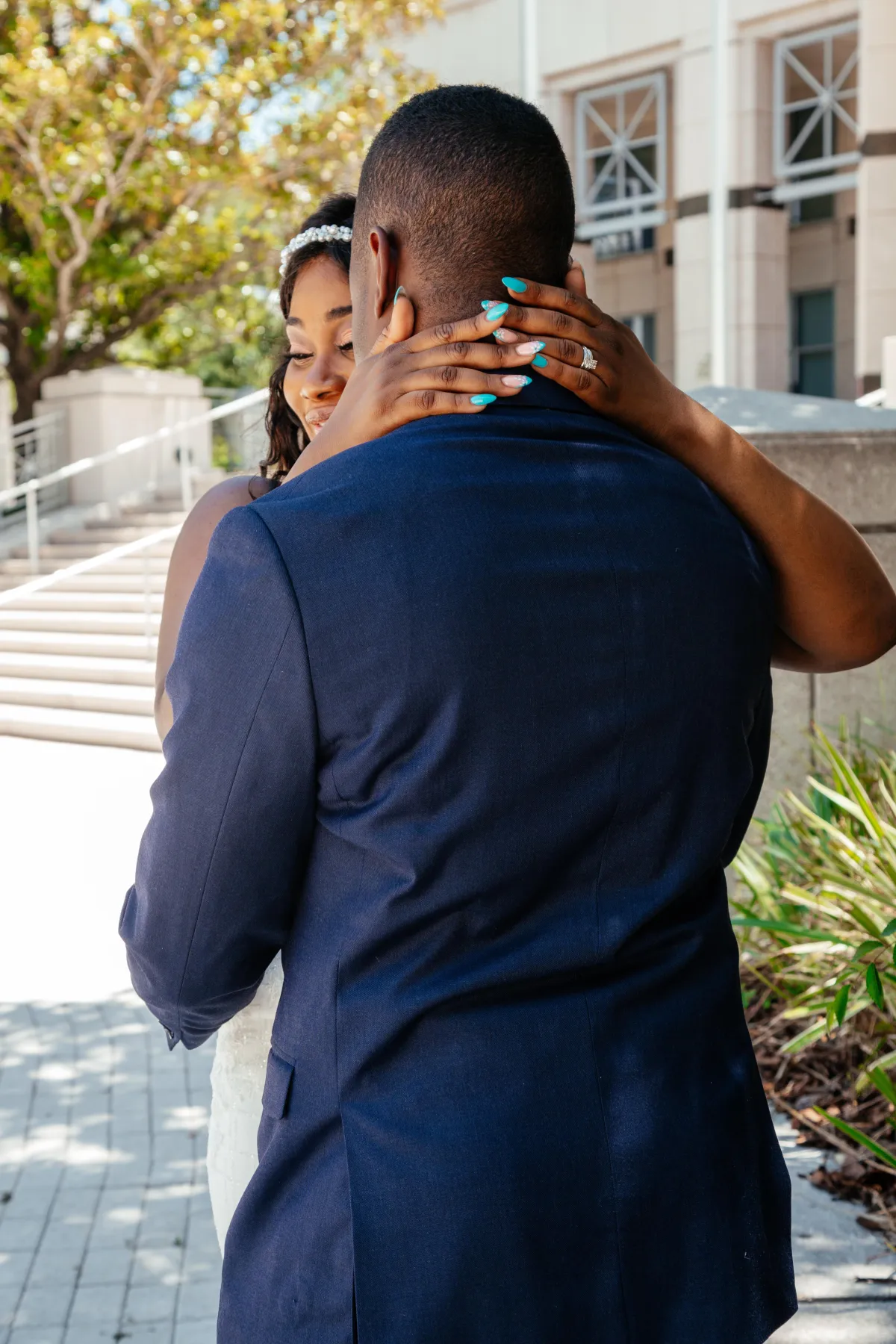 Bride and groom sharing a warm, intimate hug during their posed wedding photoshoot