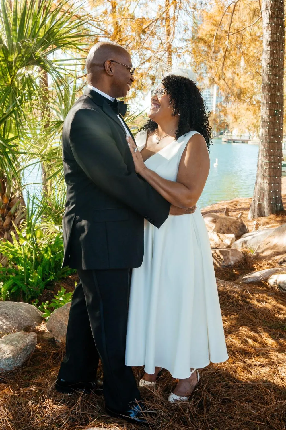 Bride and groom share a tender gaze, creating a memorable wedding photo at Lake Eola Park