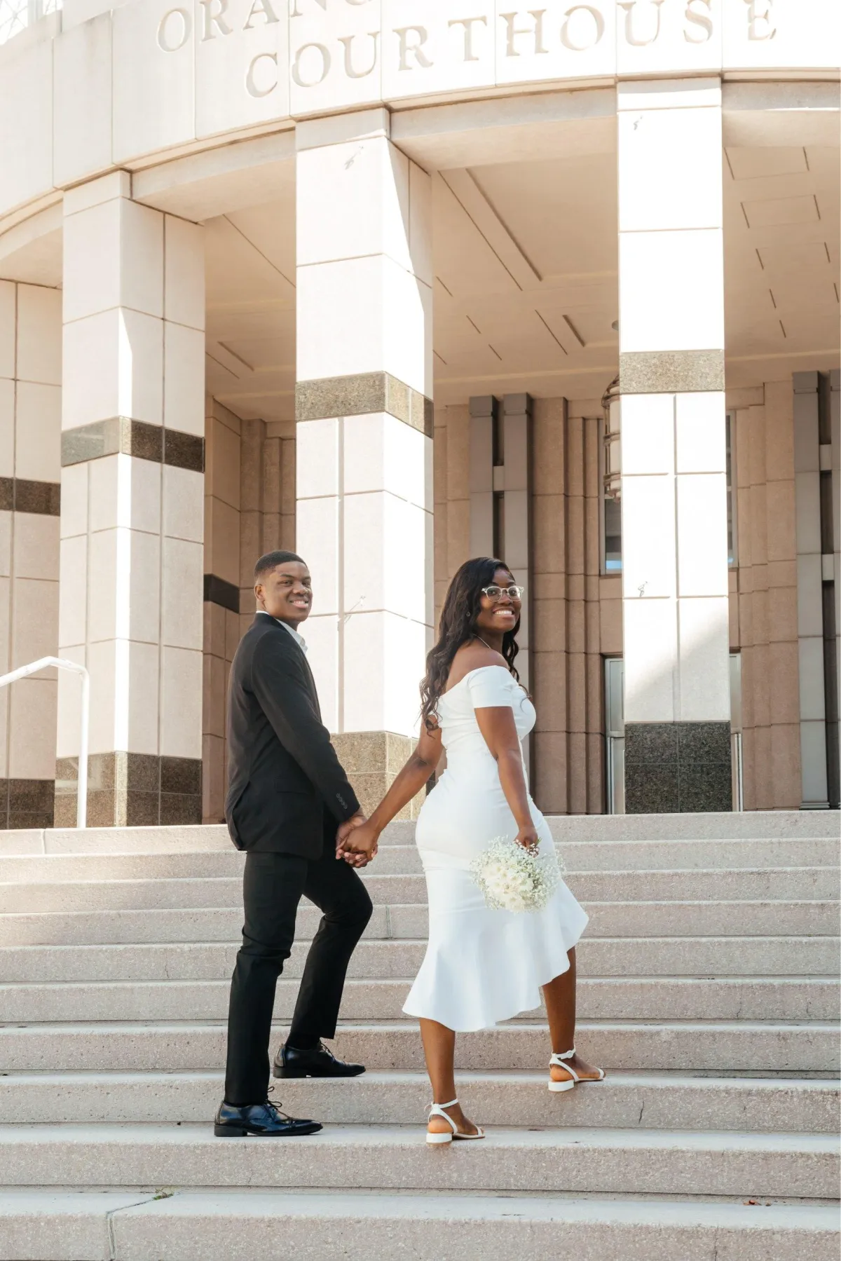 Couple walking up the steps to Orange County Courthouse