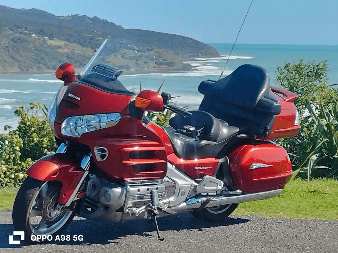Honda Goldwing GL1800 touring motorcycle overlooking the Waikato coastline, available for scenic tours and personalised riding experiences in New Zealand