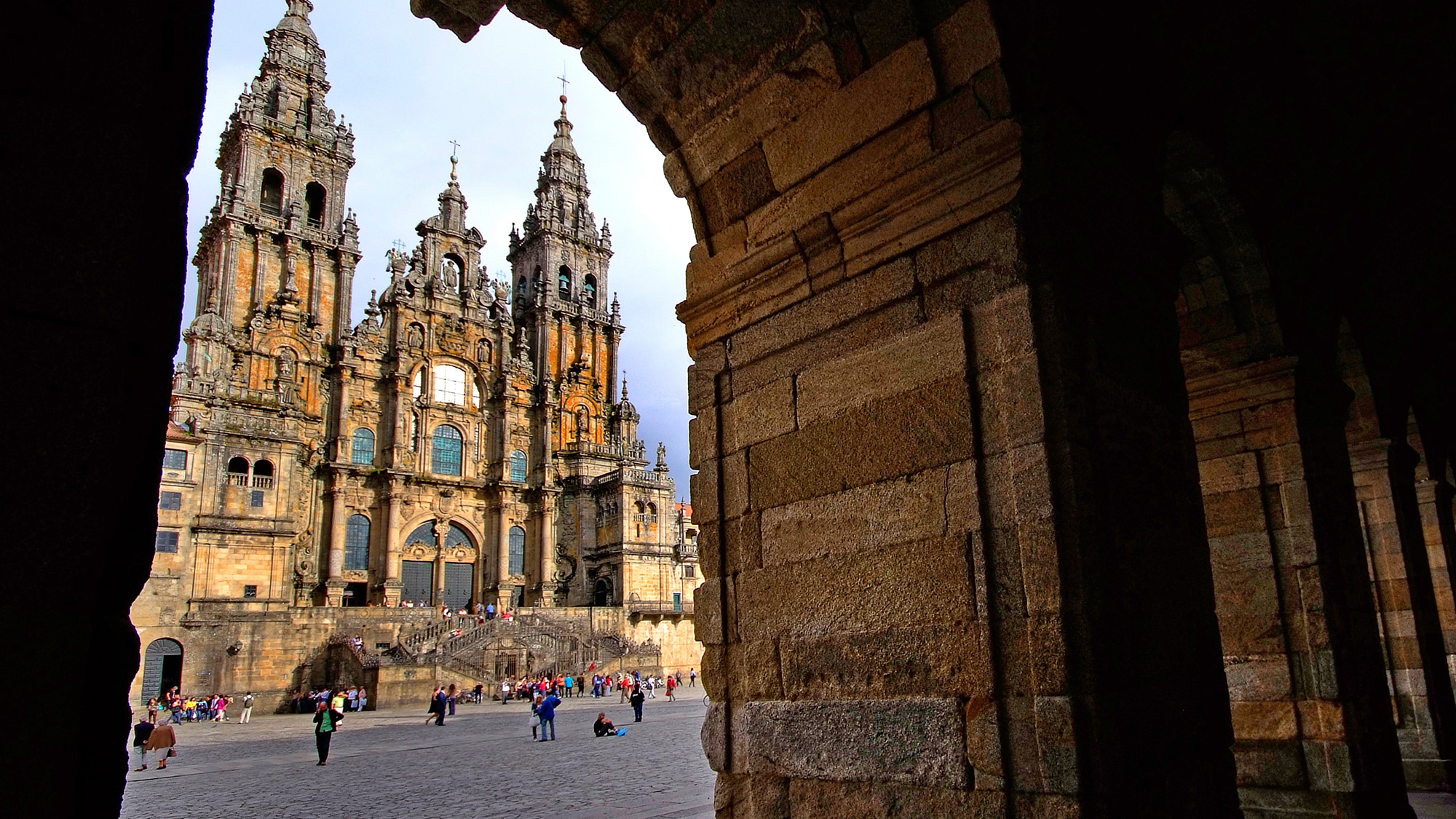 View of Santiago de Compostela Cathedral framed by a stone arch in Obradoiro Square