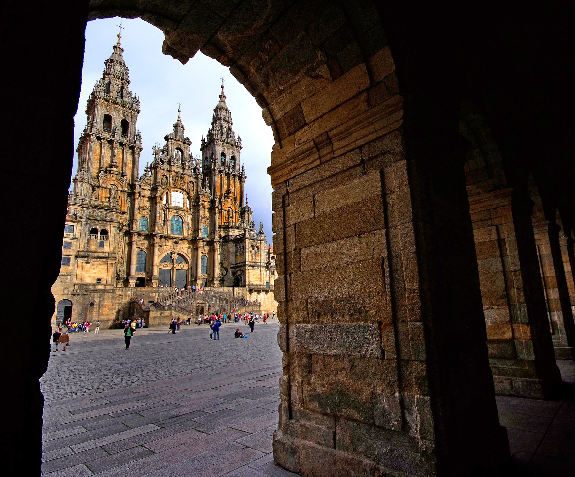 View of Santiago de Compostela Cathedral framed by a stone arch in Obradoiro Square