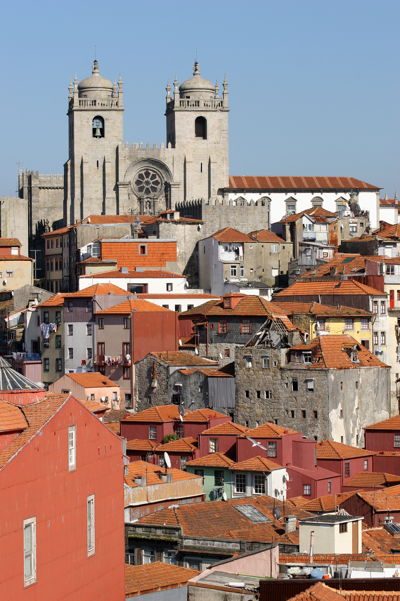 Cityscape of Porto with Sé Cathedral rising above red-tiled rooftops