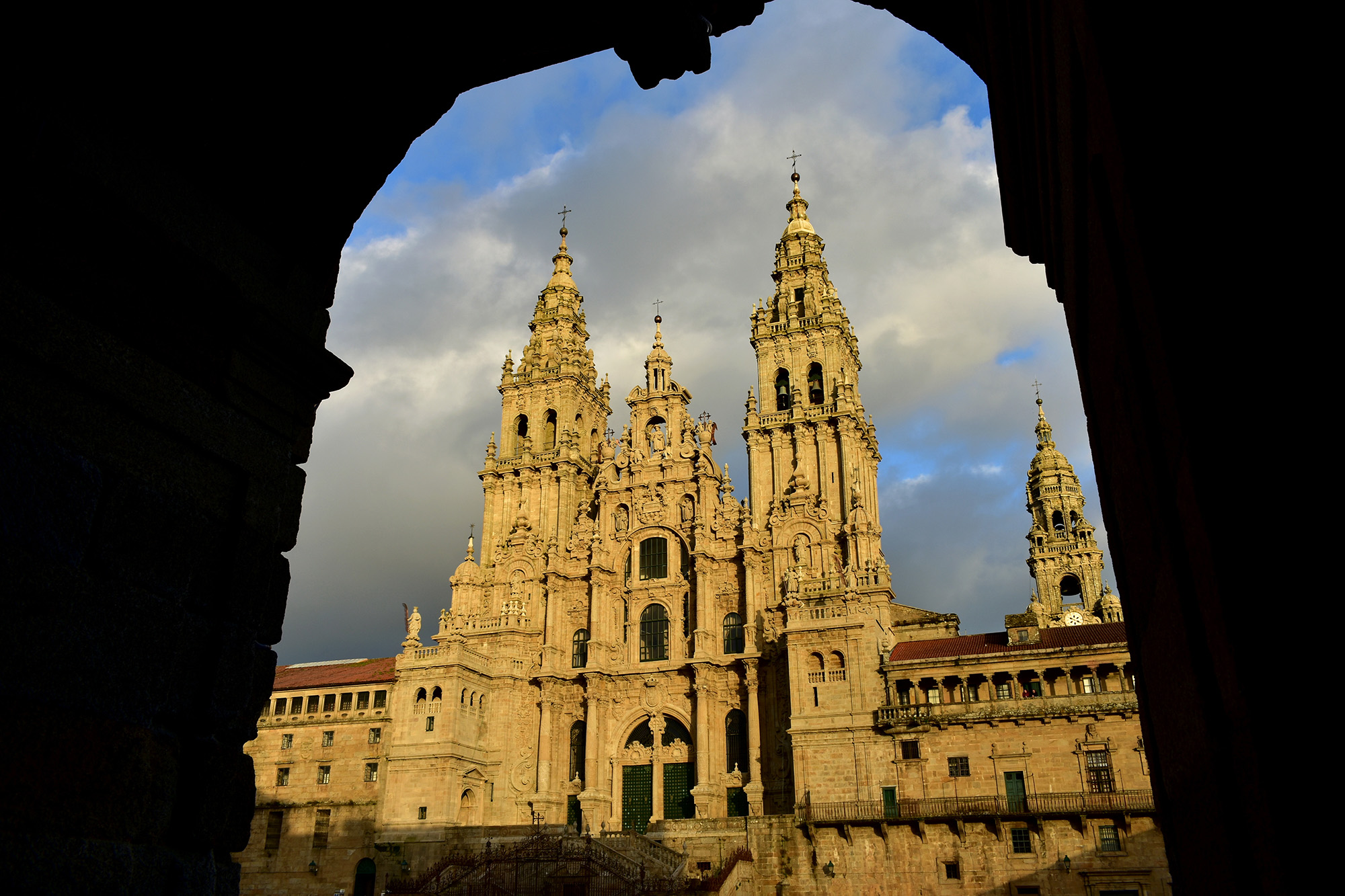 Baroque façade of Santiago de Compostela Cathedral framed by a stone arch