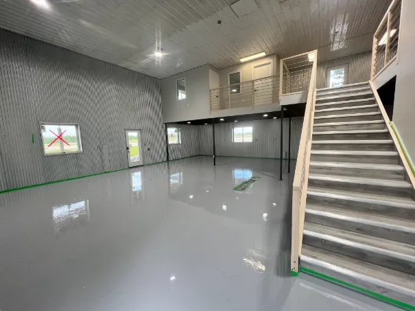 Industrial warehouse space with high-shine light grey solid epoxy floor and mezzanine