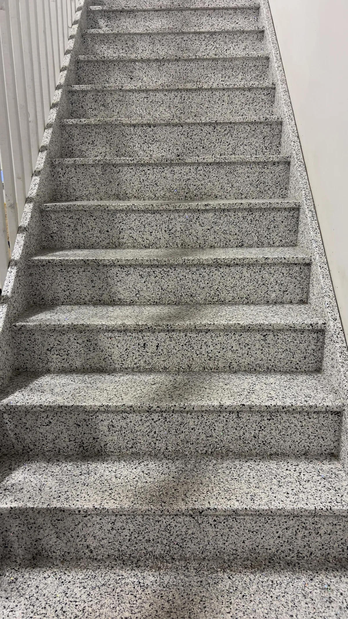 Concrete interior staircase coated in textured non-slip flake epoxy system