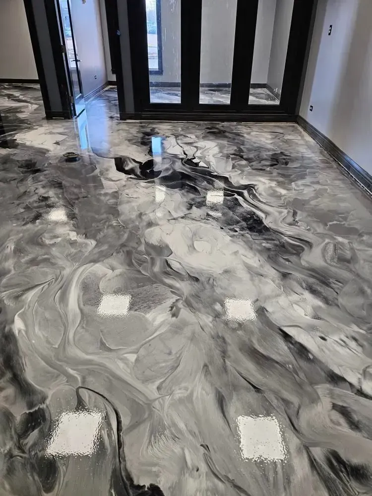 Seamless metallic epoxy flooring with black and grey marble texture in residential interior