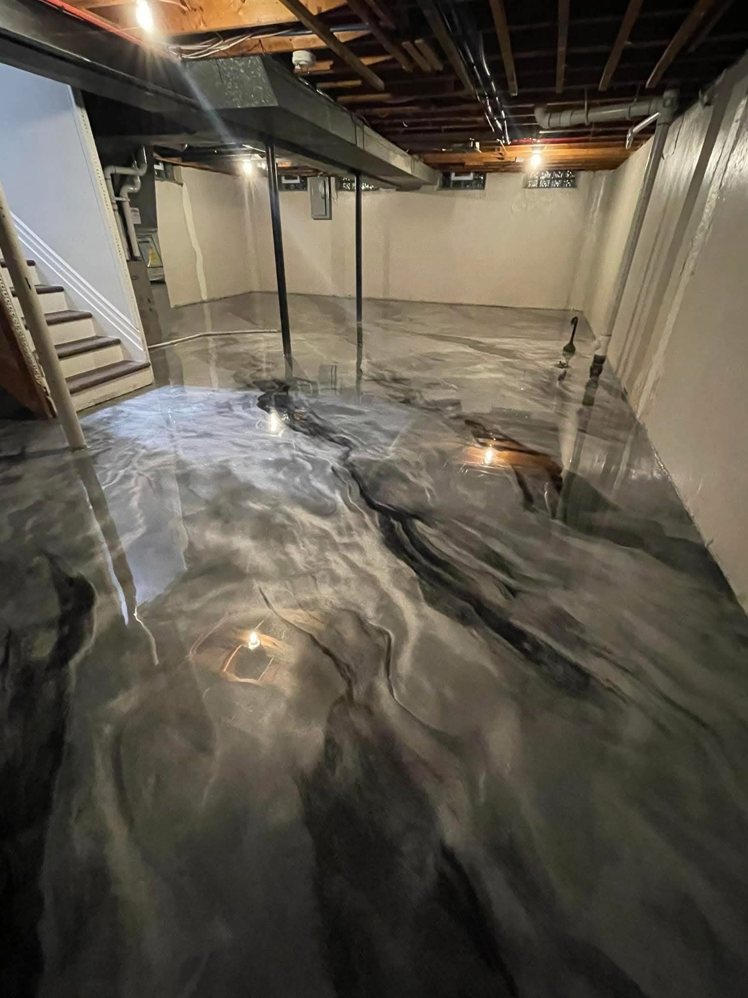 Residential basement interior with metallic epoxy flooring in custom grey tones