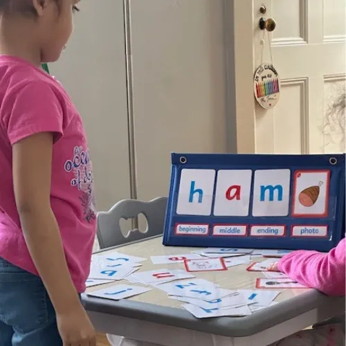 Boy picks paper out of different colored liquids