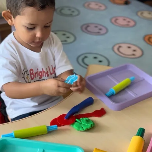 Girl follows directions during arts and crafts time.