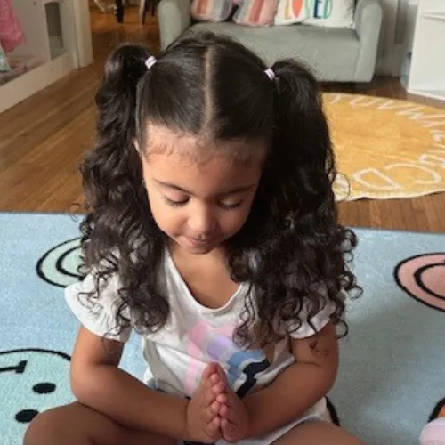 Child waves at laptop