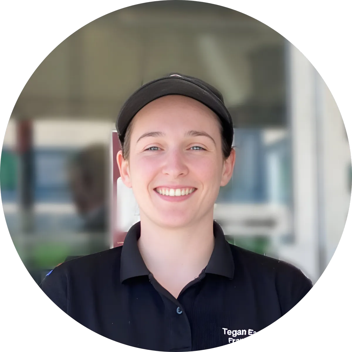 Professional headshot of a smiling individual in a black polo shirt and black cap, presented in a circular crop, conveying approachability and leadership for business coaching and fractional COO services focused on strategic operations and growth.