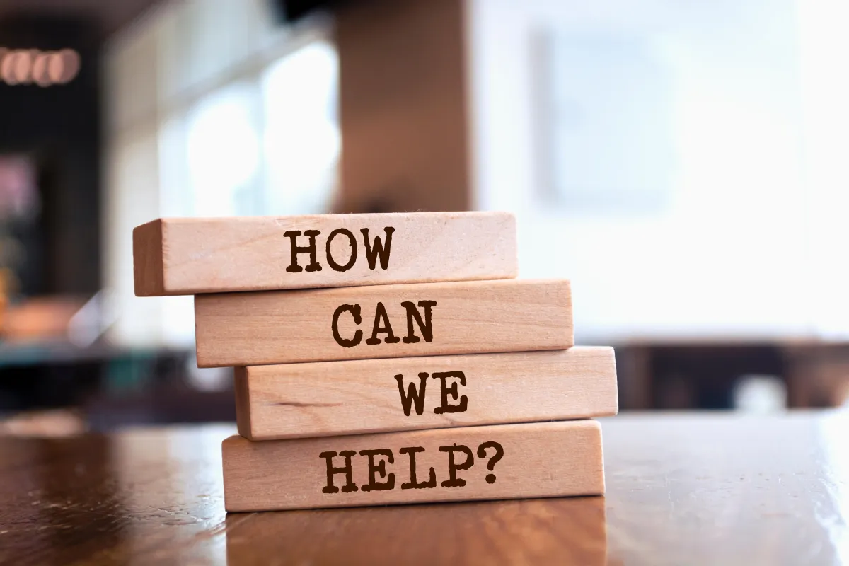 Stacked wooden blocks spelling ‘How Can We Help?’ — support for private prescription savings and personalised pharmacy service.