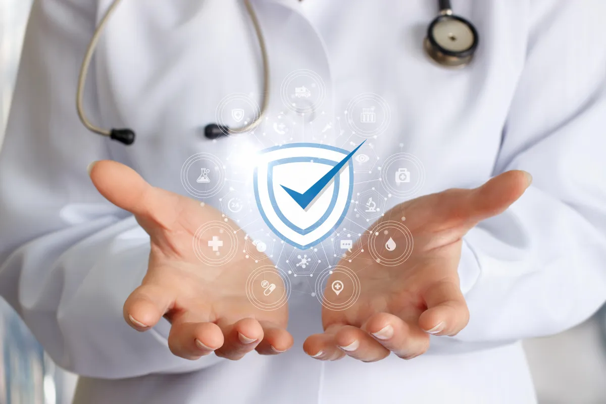 Medical professional holding a digital shield icon — symbolising safe, secure, and regulated pharmacy services.