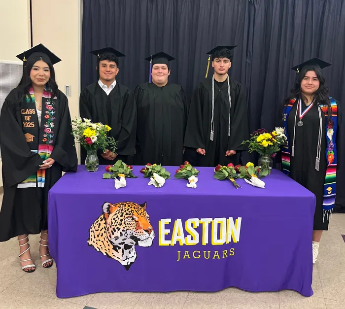 Wide view of Easton’s single PK–12 campus with brick and wood buildings framed by evergreen trees, morning light, families walking toward the entrance, photorealistic, calm nature-inspired palette highlighting community and continuity on one campus.