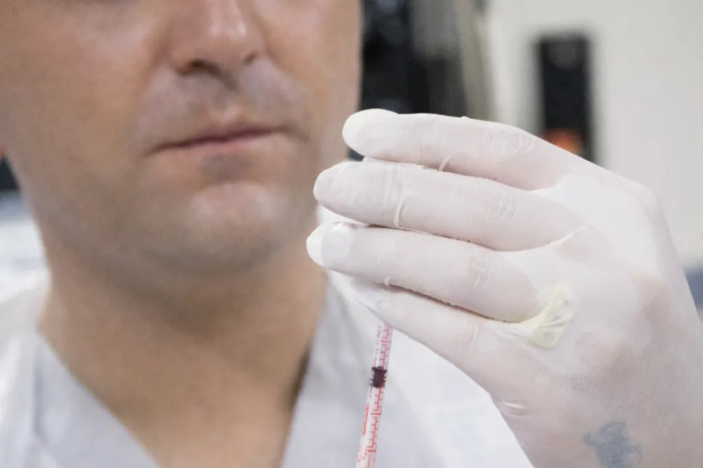 A small jar of face cream on wooden dishes