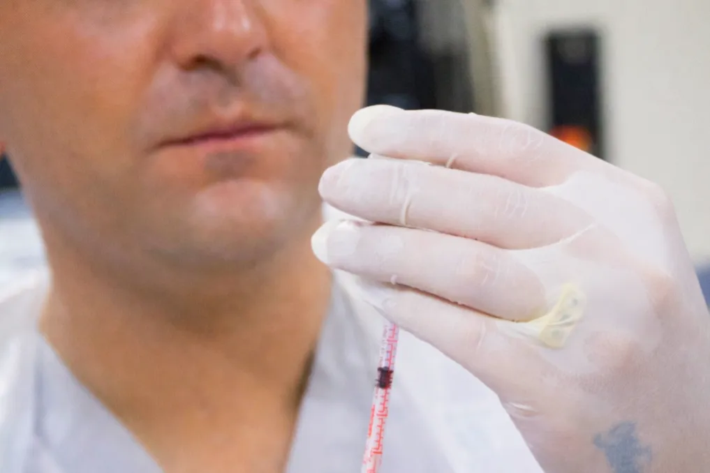 A small jar of face cream on wooden dishes
