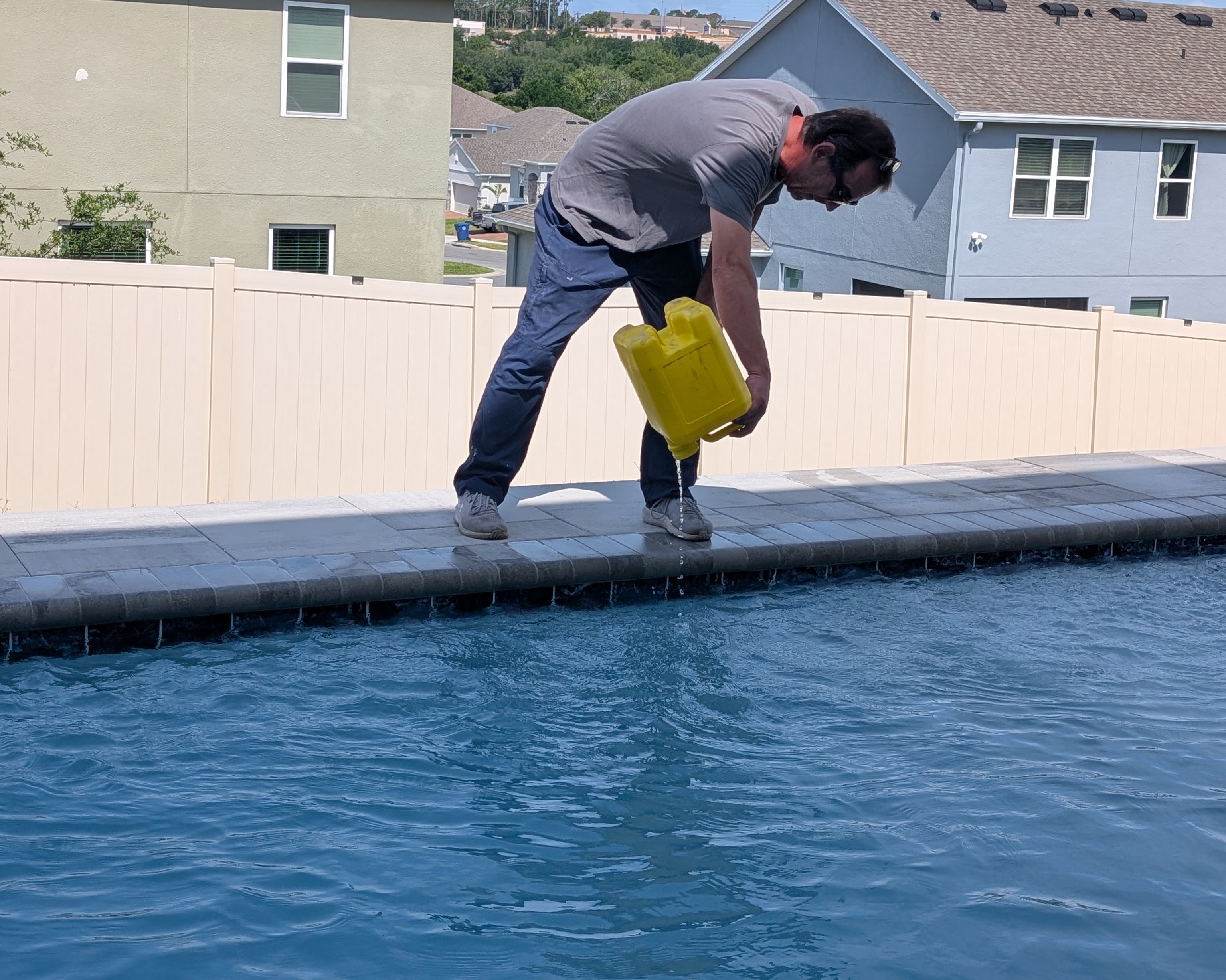 Pool ladder stands over the water.