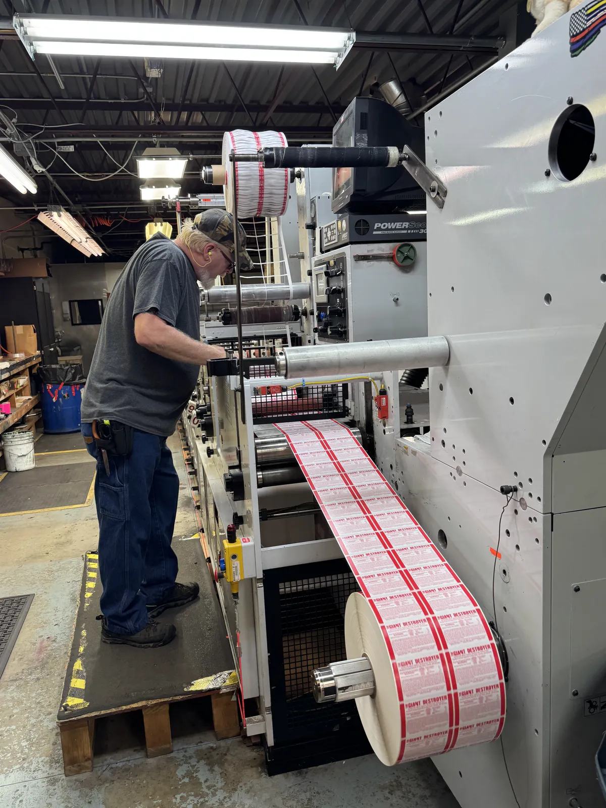 Quality control technician monitoring labels during production
