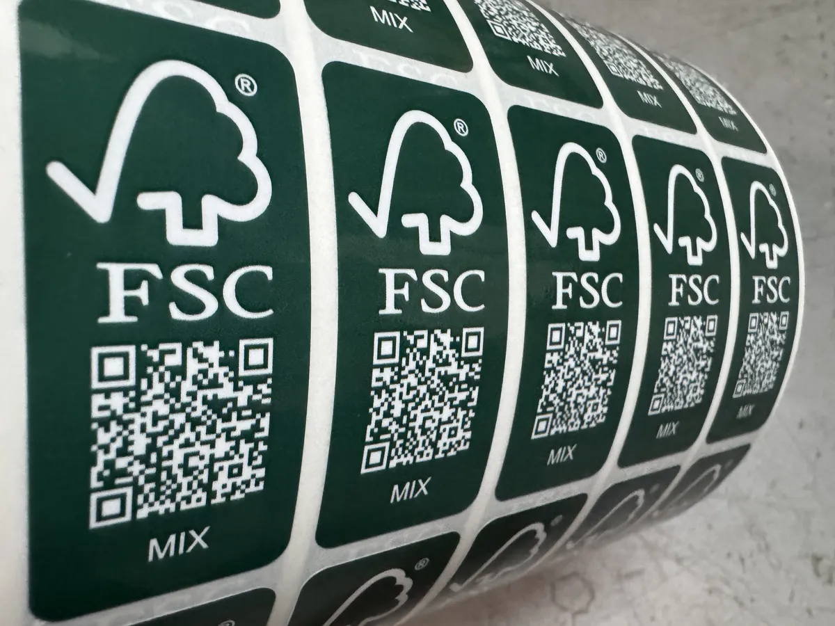 Professional label production showing finished printed label rolls on a rewinder