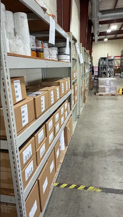 Finished rolls of professionally printed product labels staged in warehouse ready for repeat shipment