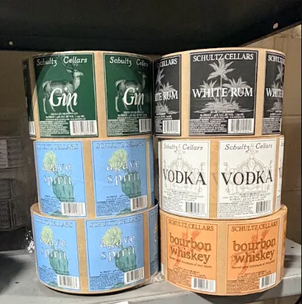 High speed roll label manufacturing press running custom printed product labels in production facility